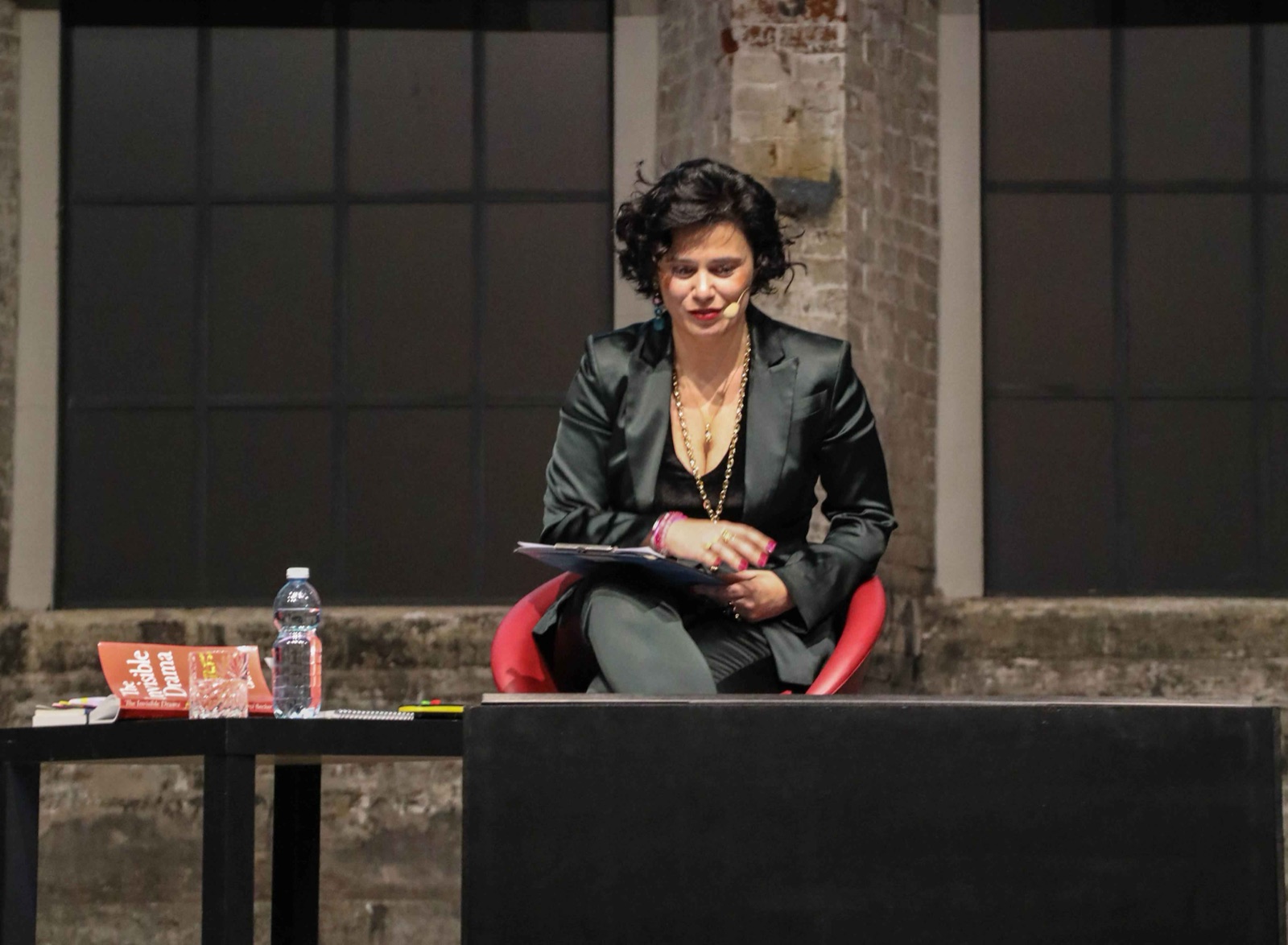 Argia Coppola speaking on stage at OGR Torino